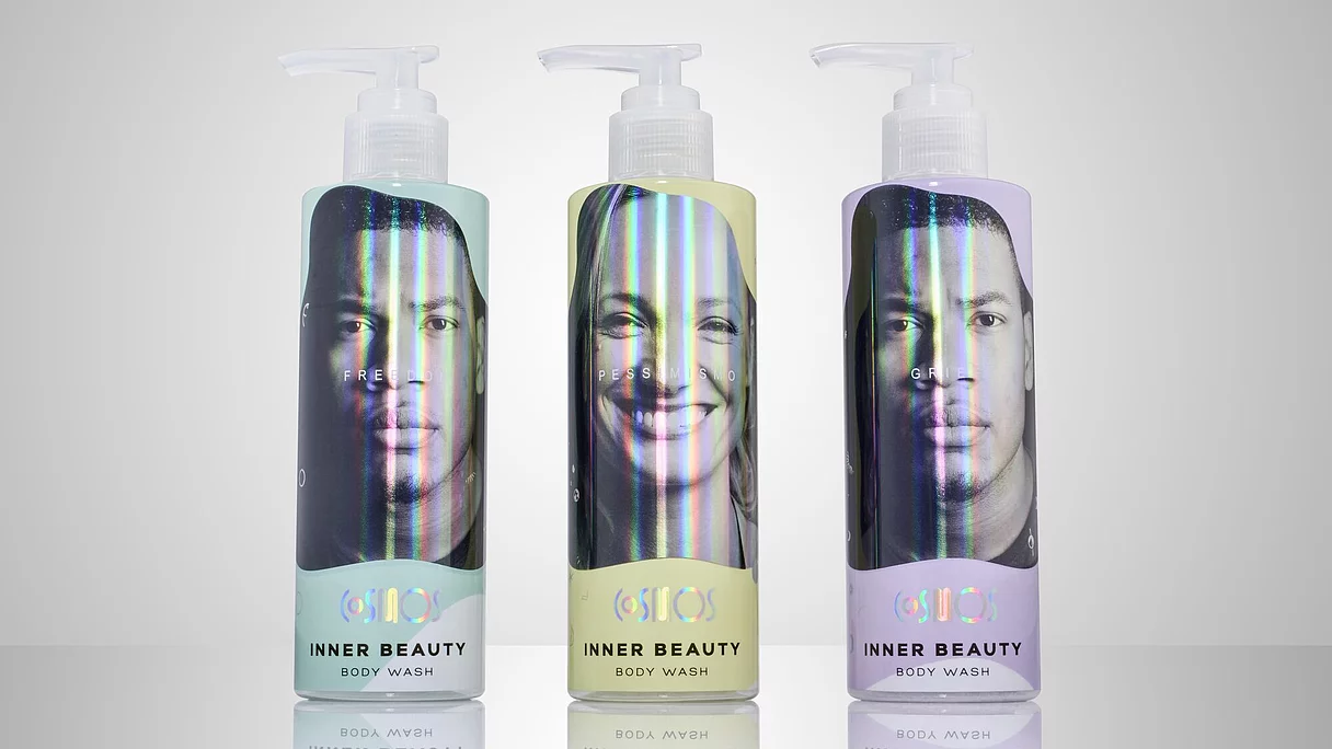 Three holographic labeled body wash bottles with black-and-white faces and text "INNER BEAUTY BODY WASH."