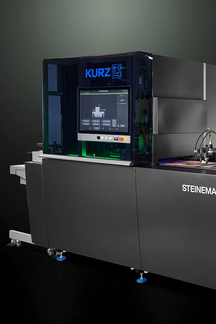 High-tech KURZ digital embellishment machine with touchscreen and colorful printed material.
