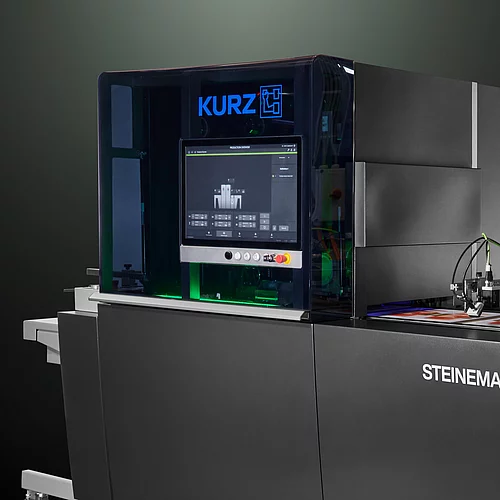 High-tech KURZ digital embellishment machine with touchscreen and colorful printed material.