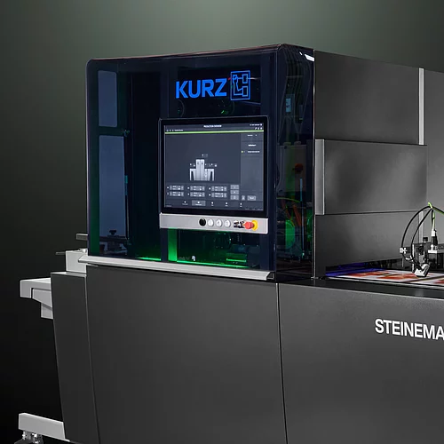 High-tech KURZ digital embellishment machine with touchscreen and colorful printed material.