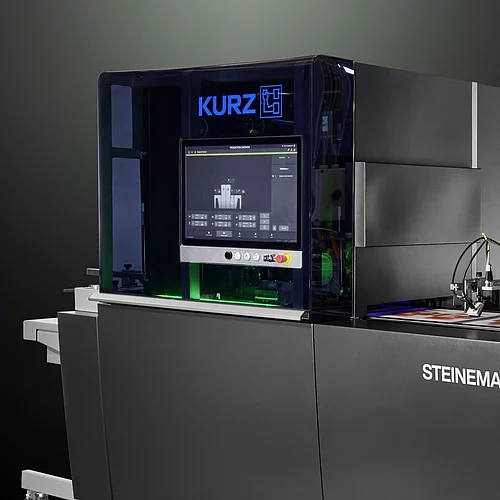 High-tech KURZ digital embellishment machine with touchscreen and colorful printed material.