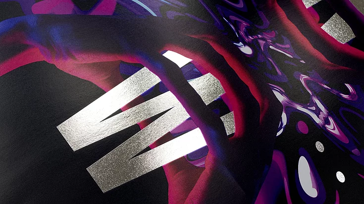 Close-up of a dark, glossy surface with bold silver letters spelling ‘WIN’ and abstract colorful patterns in red and purple.