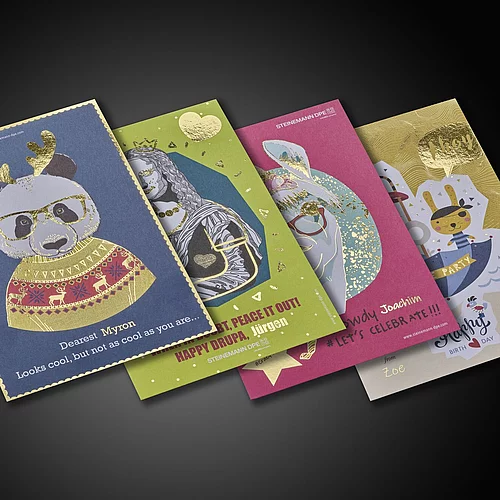 Four colorful greeting cards with gold foil details, featuring a panda in festive attire, a lion queen, a rabbit with glasses, and a pirate bunny, each with playful designs and personalized names.