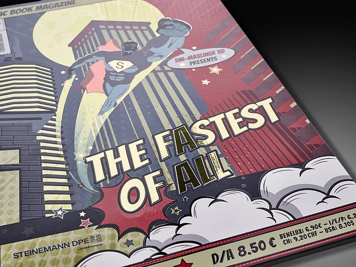 Comic book-style magazine cover titled “The Fastest of All” with superhero artwork, embossed elements, and metallic foil effects produced using KURZ DM-MAXLINER 3D technology. 