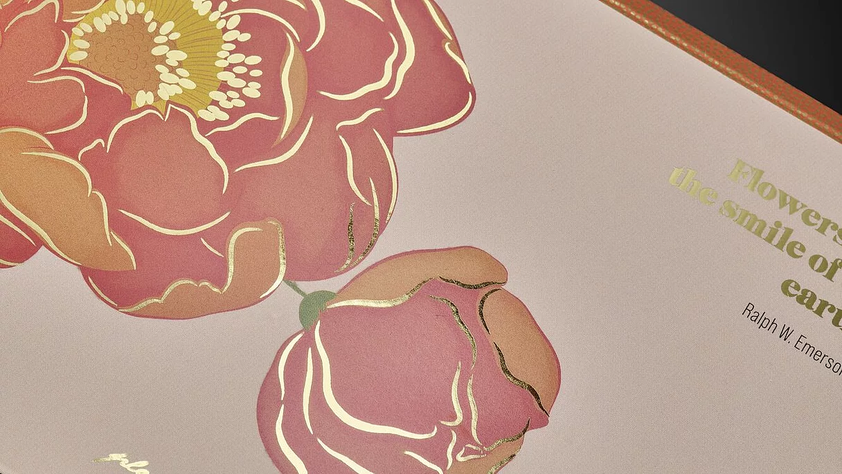 Light pink sheet with orange-red flower and gold foil accents on petals and text.