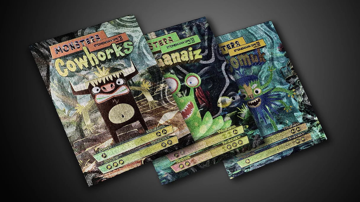 Three colorful trading card-style prints featuring cartoon monsters with stats for power, weakness, resistance, and retreat on a dark background.