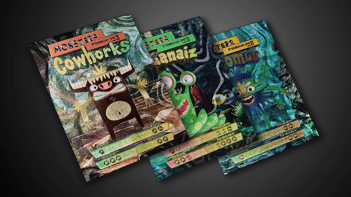 Three colorful trading card-style prints featuring cartoon monsters with stats for power, weakness, resistance, and retreat on a dark background.