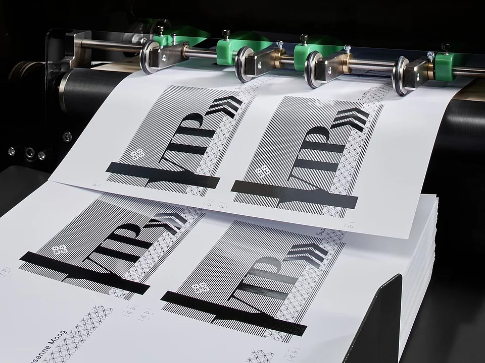 Label printing machine producing black and white "VIP" labels on sheets.