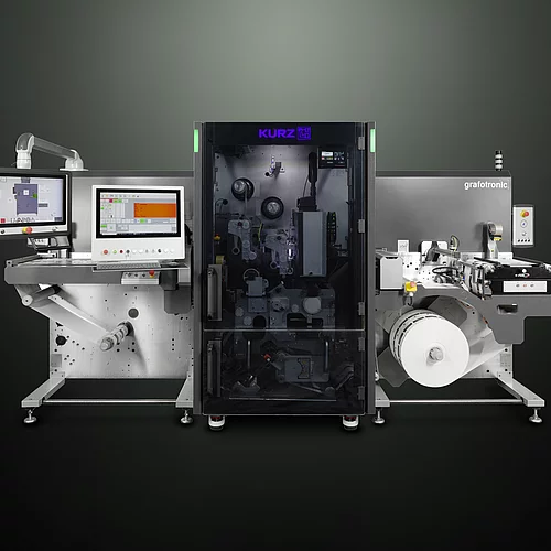 digital embellishment machine with control screens, labeled "KURZ" and "grafotronic," showing a roll of material.