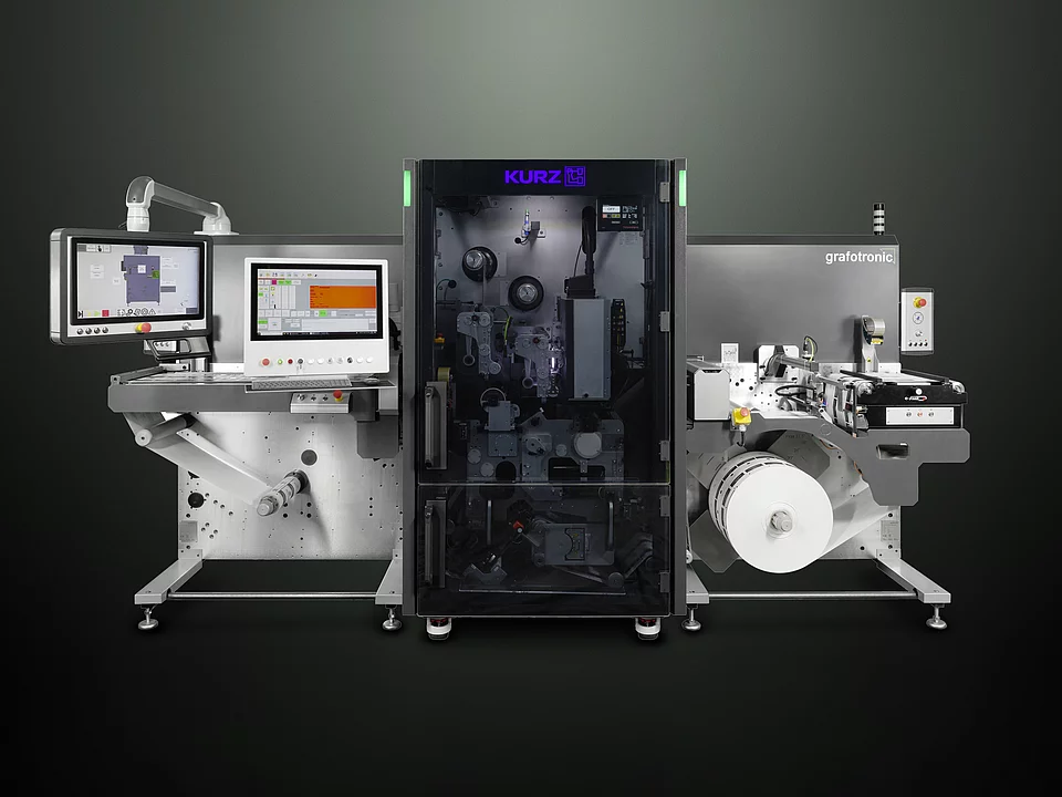 digital embellishment machine with control screens, labeled "KURZ" and "grafotronic," showing a roll of material.