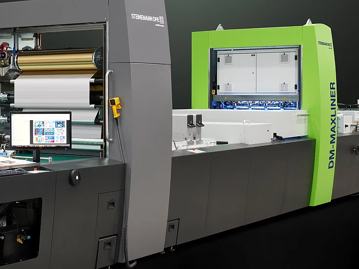Kurz Digital Embellishement Solution with gray and green components labeled "STEINEMANN DPE" and "DM-MAXLINER," used for high-speed spot coating and metallization.