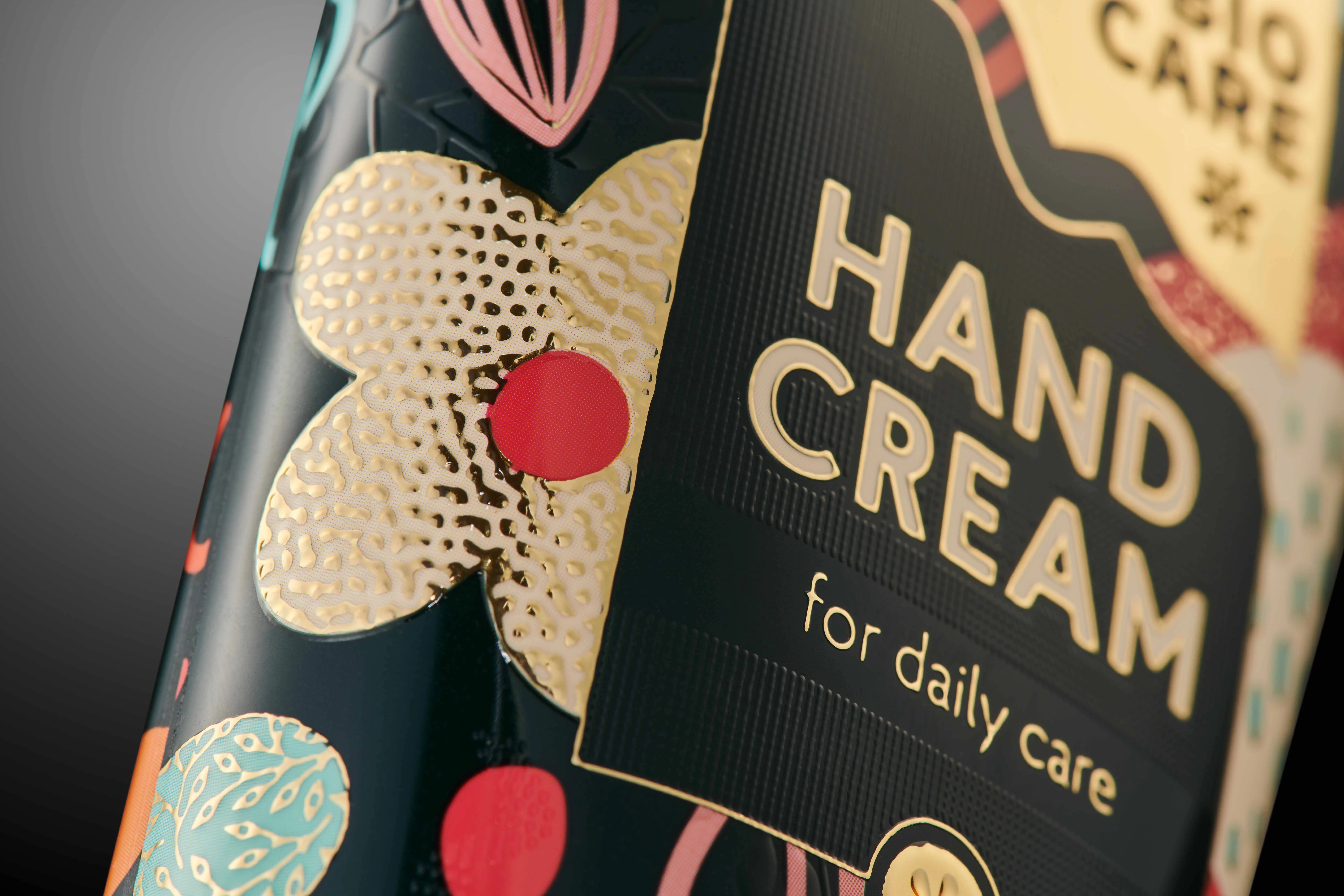 Close-up of a colorful hand cream bottle label with floral designs and text "BIO CARE HAND CREAM for daily care."