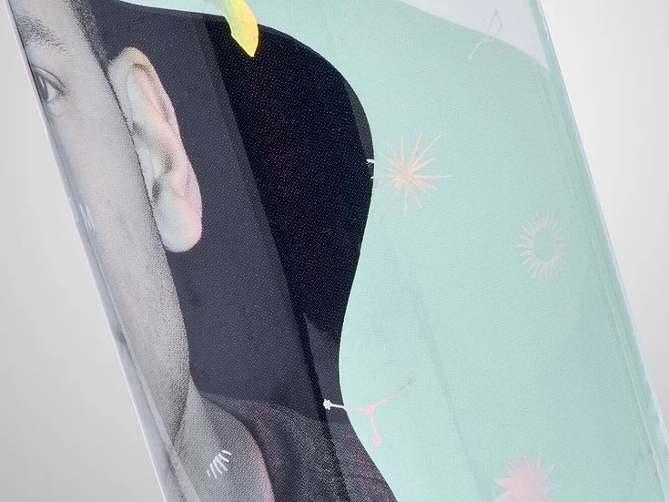 Close-up of a cosmetic bottle design featuring pastel tones, a partial face image, and delicate holographic foil elements like constellations, stars, and planets—emphasizing subtle premium detailing.