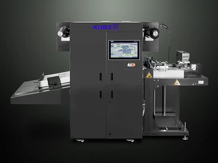 Digital Embellishment Solution from KURZ with open compartment, processing stacked printed sheets labeled "VIP".
