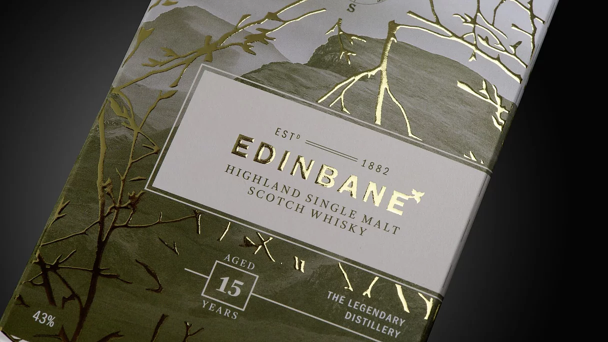 Premium packaging for EDINBANE Highland Single Malt Scotch Whisky with gold foil embellishment and embossed details on a matte background.