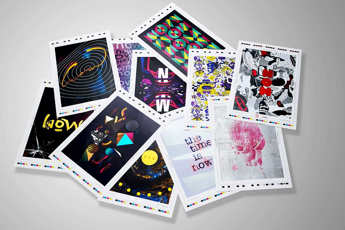 A scattered collection of colorful art prints or postcards featuring various abstract and graphic designs on a white background.