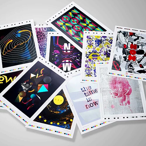 A scattered collection of colorful art prints or postcards featuring various abstract and graphic designs on a white background.
