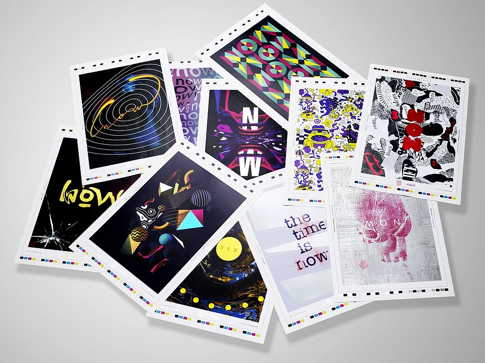 A scattered collection of colorful art prints or postcards featuring various abstract and graphic designs on a white background.