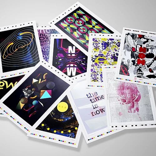A scattered collection of colorful art prints or postcards featuring various abstract and graphic designs on a white background.