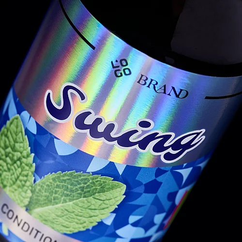 Close-up of a “Swing” conditioner bottle label with vibrant holographic foil effects and mint leaf imagery, showcasing premium digital embellishment.