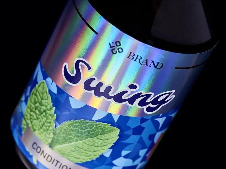 Close-up of a “Swing” conditioner bottle label with vibrant holographic foil effects and mint leaf imagery, showcasing premium digital embellishment.