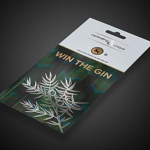 Packaging with silver juniper branch and gold text “WIN THE GIN”.