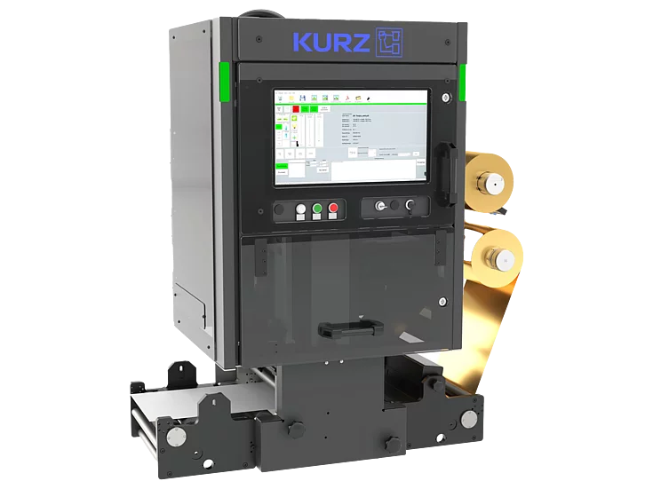 Compact KURZ digital foil unit with touchscreen interface and dual gold foil rolls, used for automated embellishment in narrow-web printing applications.