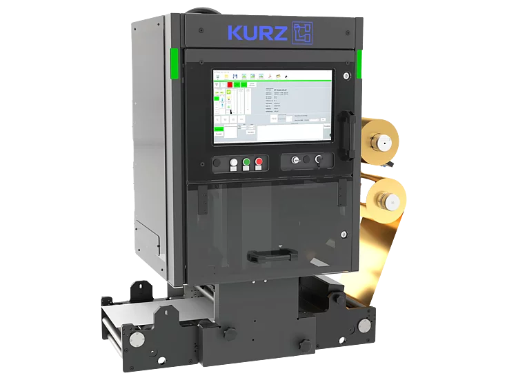 Compact KURZ digital foil unit with touchscreen and dual gold foil rolls for automated narrow-web embellishment.