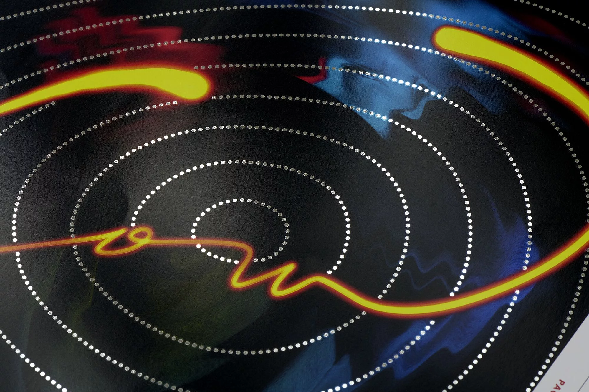 Abstract design with concentric silver dotted circles on a dark background, intersected by a glowing orange wavy line.