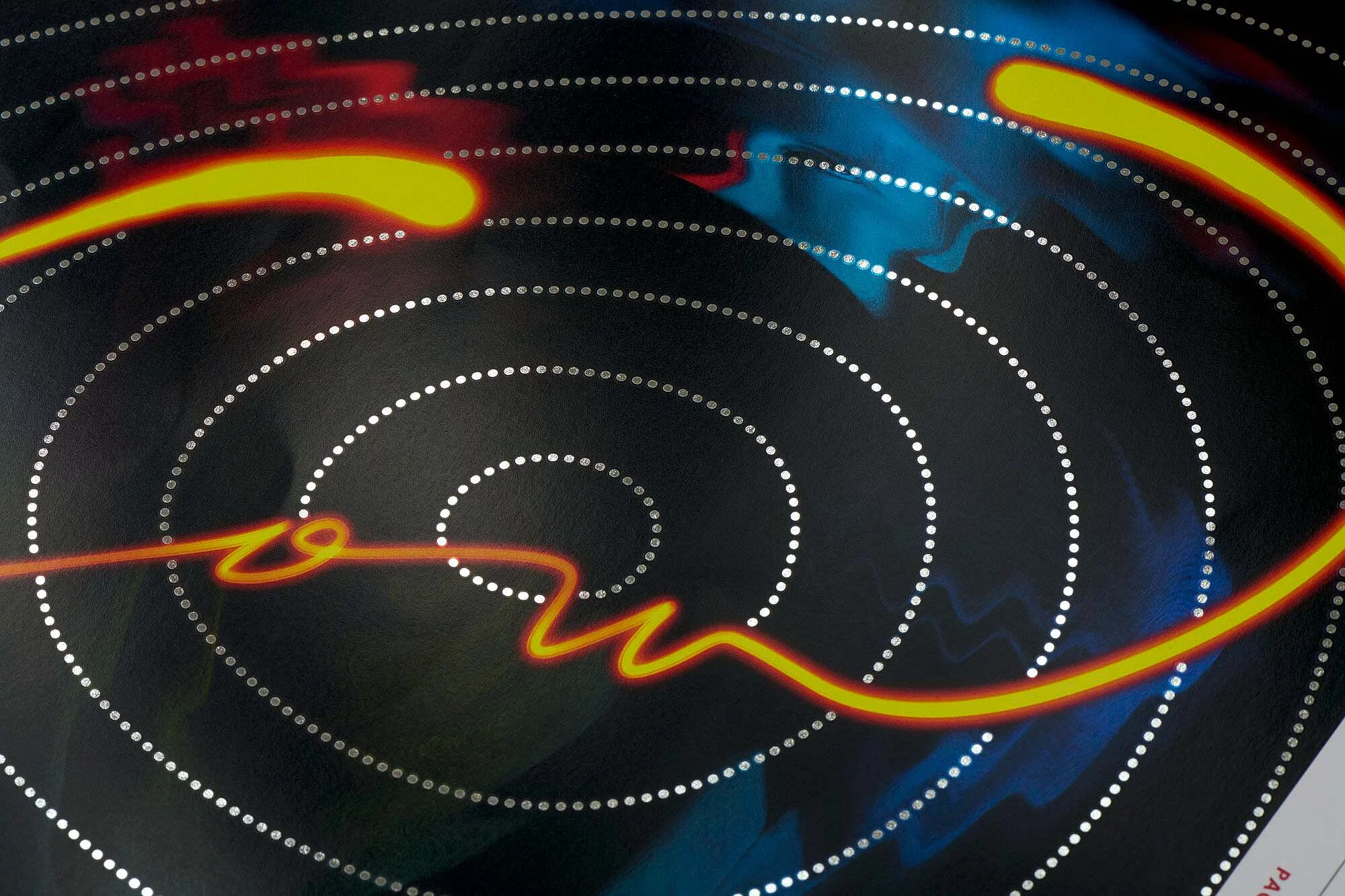 Abstract design with concentric silver dotted circles on a dark background, intersected by a glowing orange wavy line.