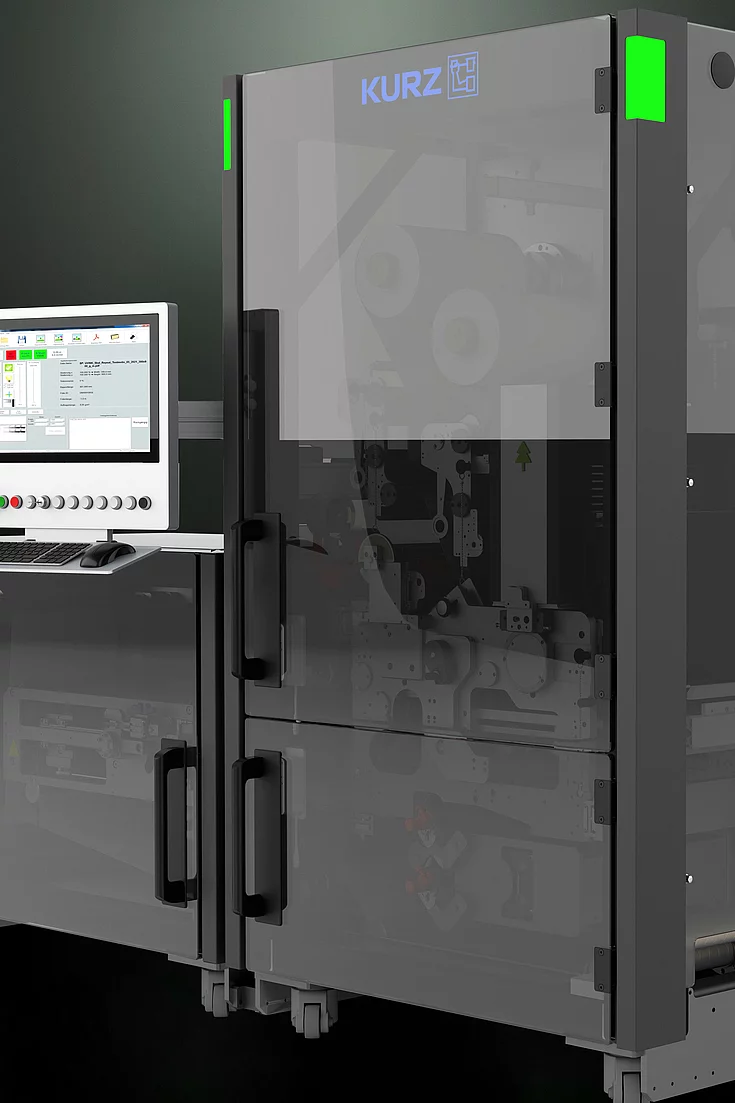 Close-up of a modern industrial machine with a transparent door and control panel.